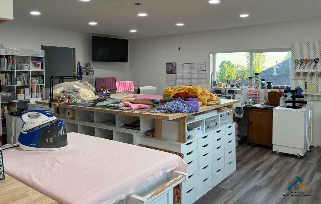Custom home office remodeling with large worktable, built-in drawer storage, and organized craft workspace designed by FIXI LLC in Utah.